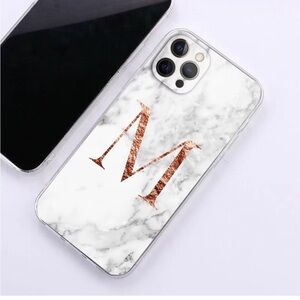 White marble pattern iPhone 13 Pro Max case with a large Rose Gold Letter M